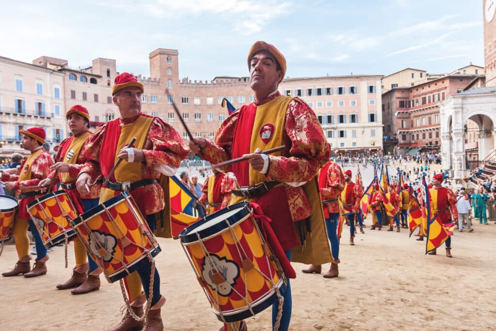 Men musicians with drums in historical colorful costumes